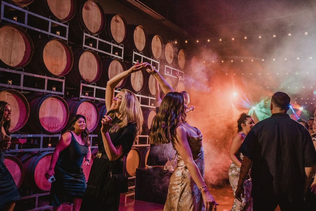 Two women on the dance floor at the Cask Room in Domenico Winery celebrating an event