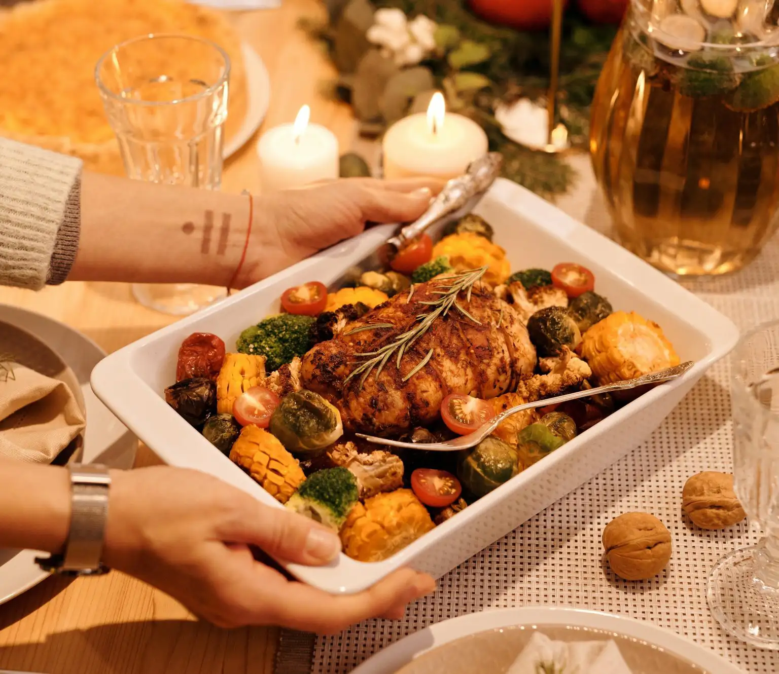 Roasted chicken with vegetables being served on a holiday dining table